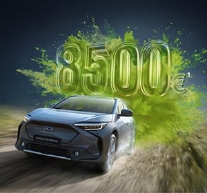 Subaru Solterra fährt auf Straße, dahinter große grüne Zahl '8.500€'